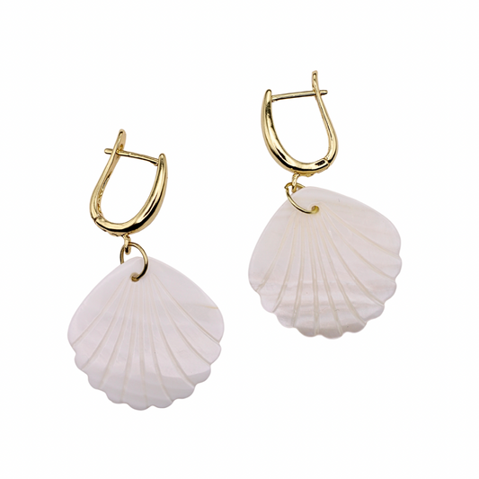 The Abigail earrings are the perfect light and airy beach accessory. They are made with nickel free gold plated hoops and engraved shell charms. 